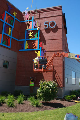 Attaching the south wall sculpture to the wall